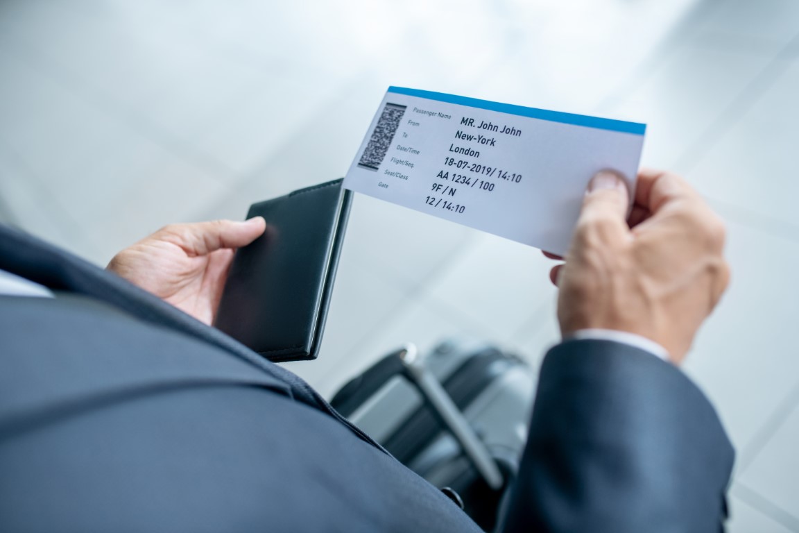 male-hands-holding-passport-and-plane-ticket-2021-09-22-01-40-51-utc1